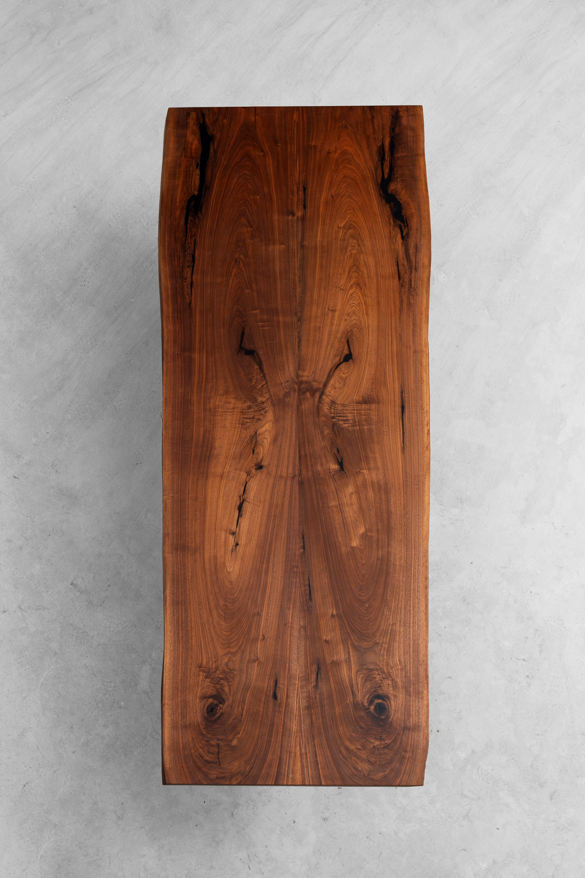 Aerial view of Resonance Table featuring symmetrical bookmatched black walnut with mirrored wood grain.