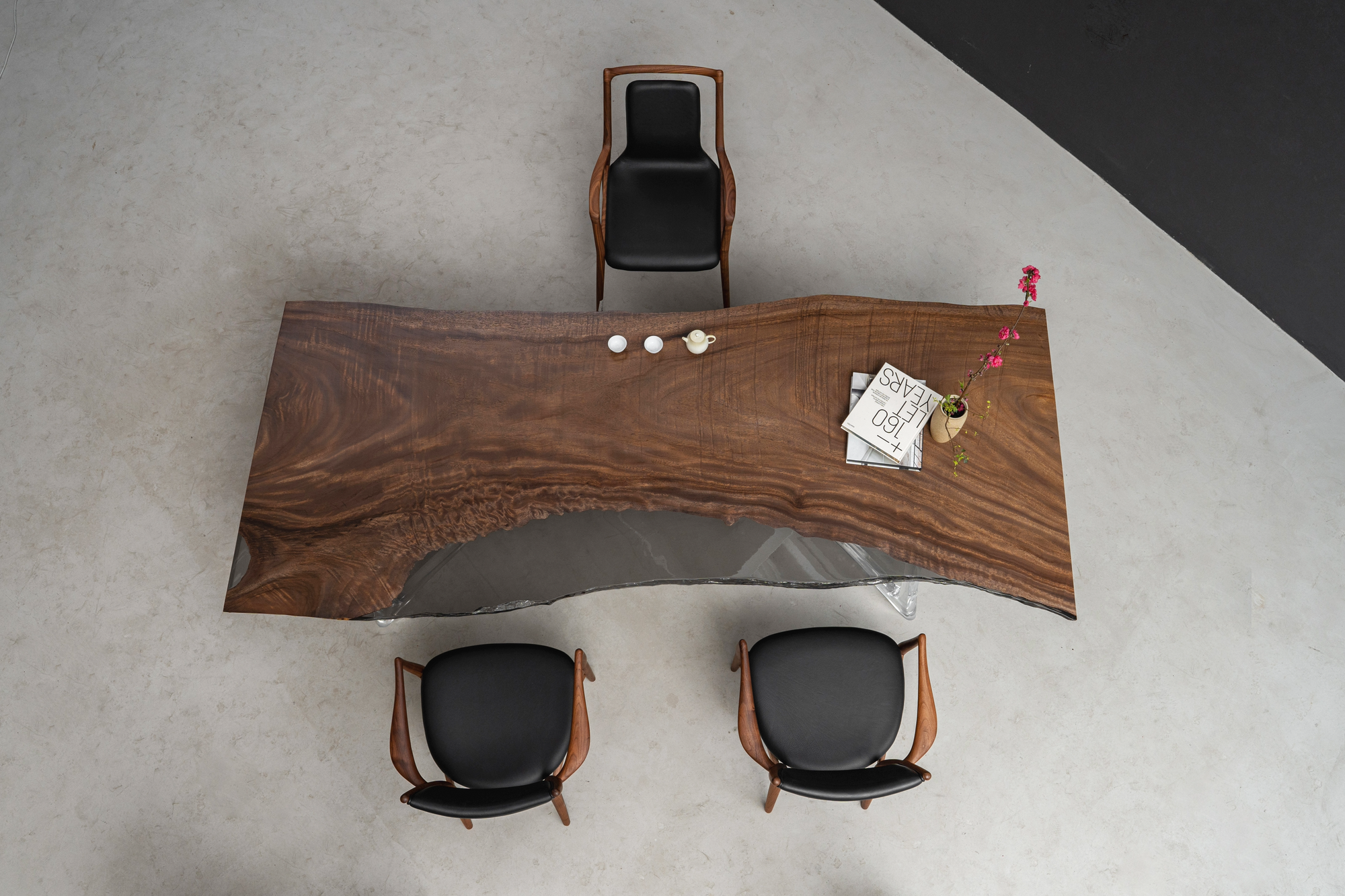 Overhead view of the Silent Basin Table with chairs, highlighting the rainwood slab and epoxy feature.