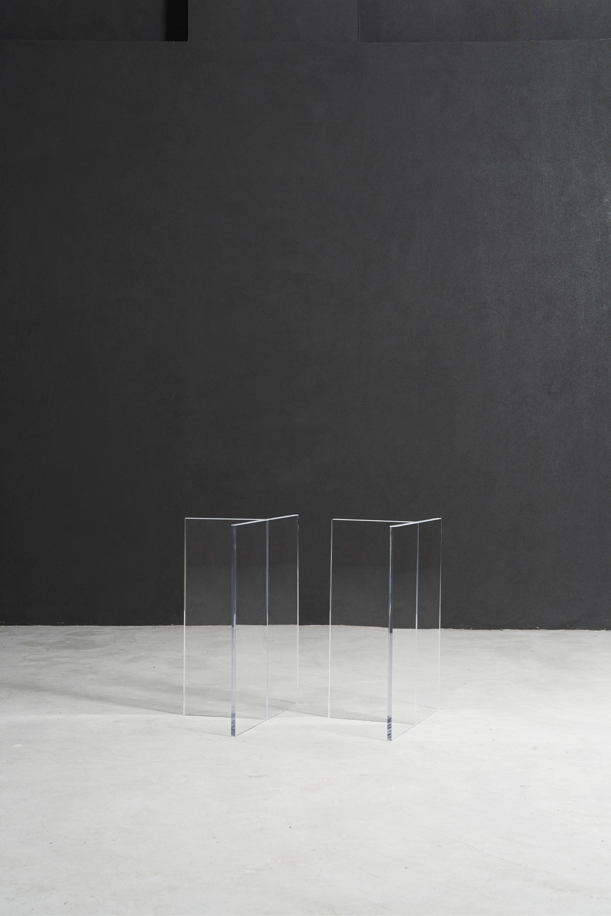 Clear acrylic Silent T base providing minimalist support for a live edge table.