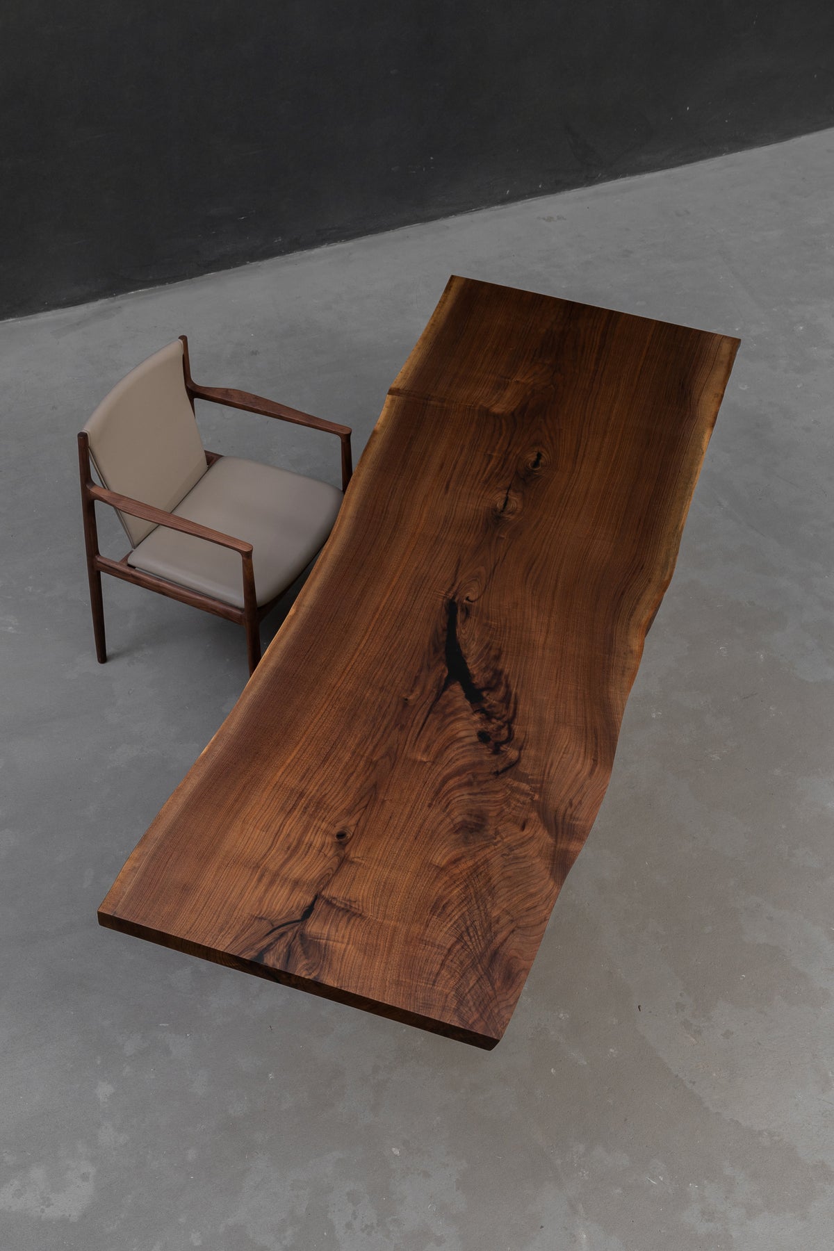 angled overhead view of span of influence black walnut table by woodslabs