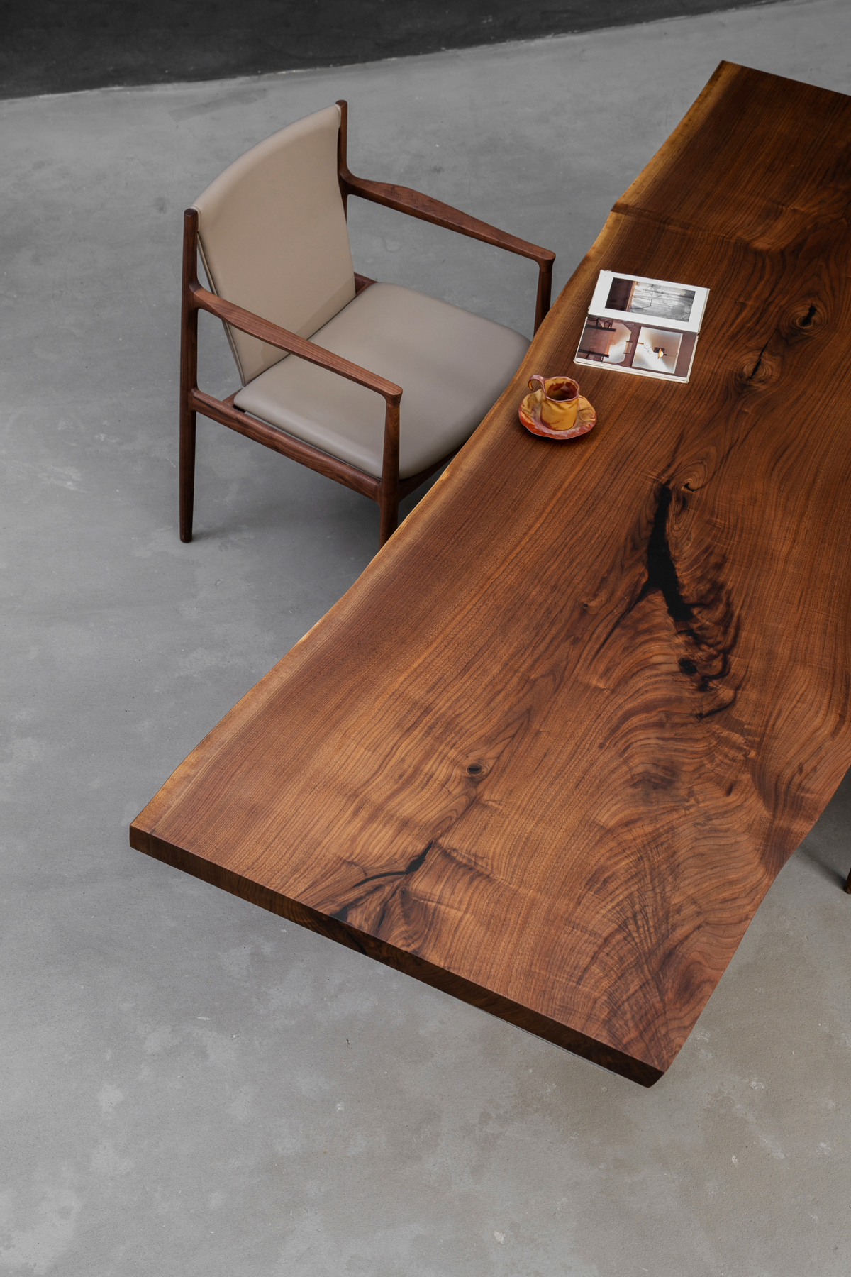 Three quarter view of Span of Influence black walnut tabletop revealing natural grain pattern and solid wood surface