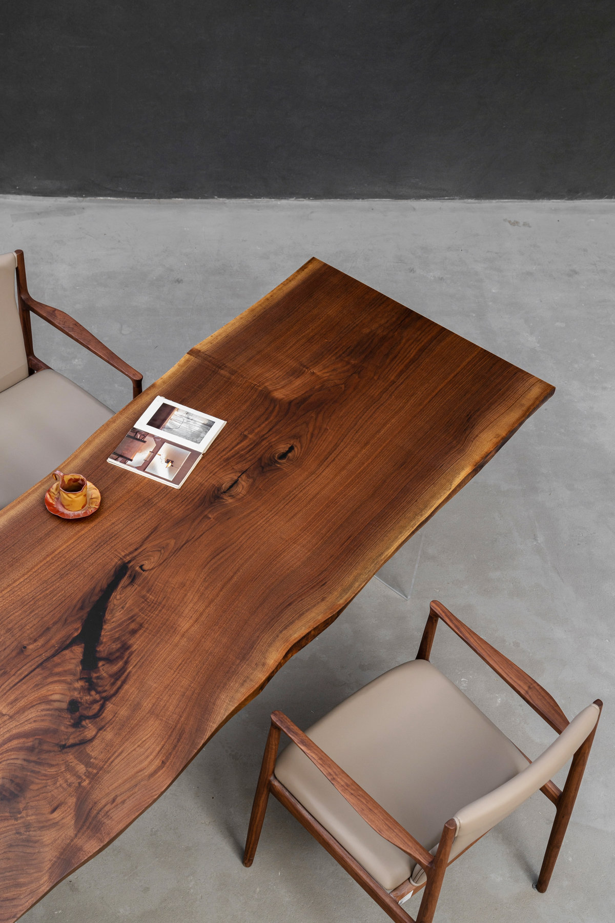 Overhead three quarter view of Span of Influence black walnut tabletop revealing natural grain pattern and solid wood surface