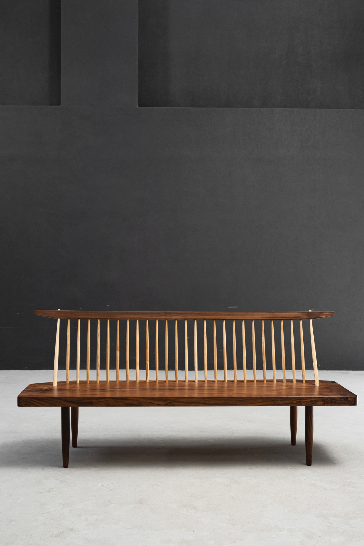 String Theory Bench showcasing harmonious balance between solid walnut and delicate spindles.