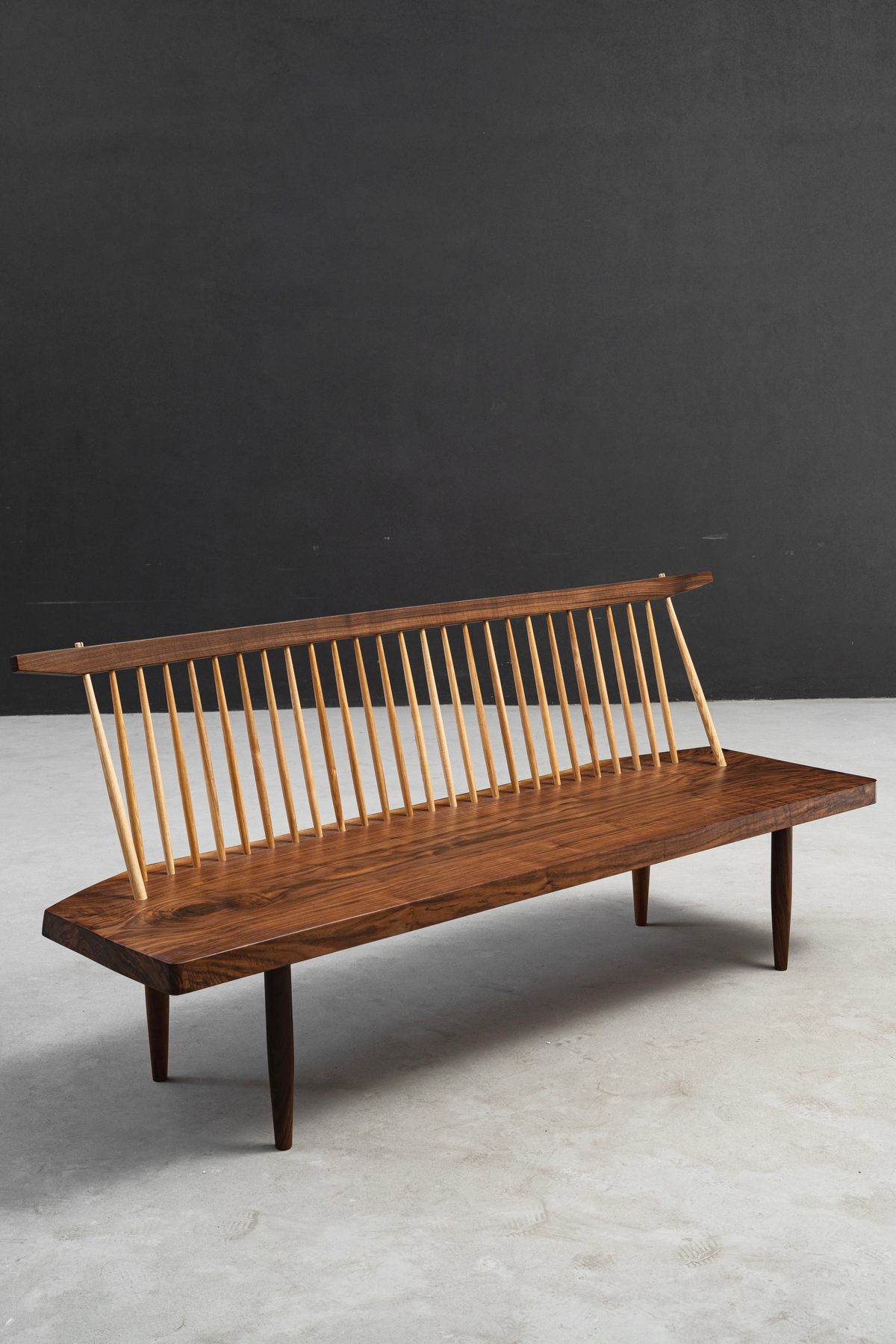 Perspective shot highlighting the bench's sweeping curves and precise angular composition.