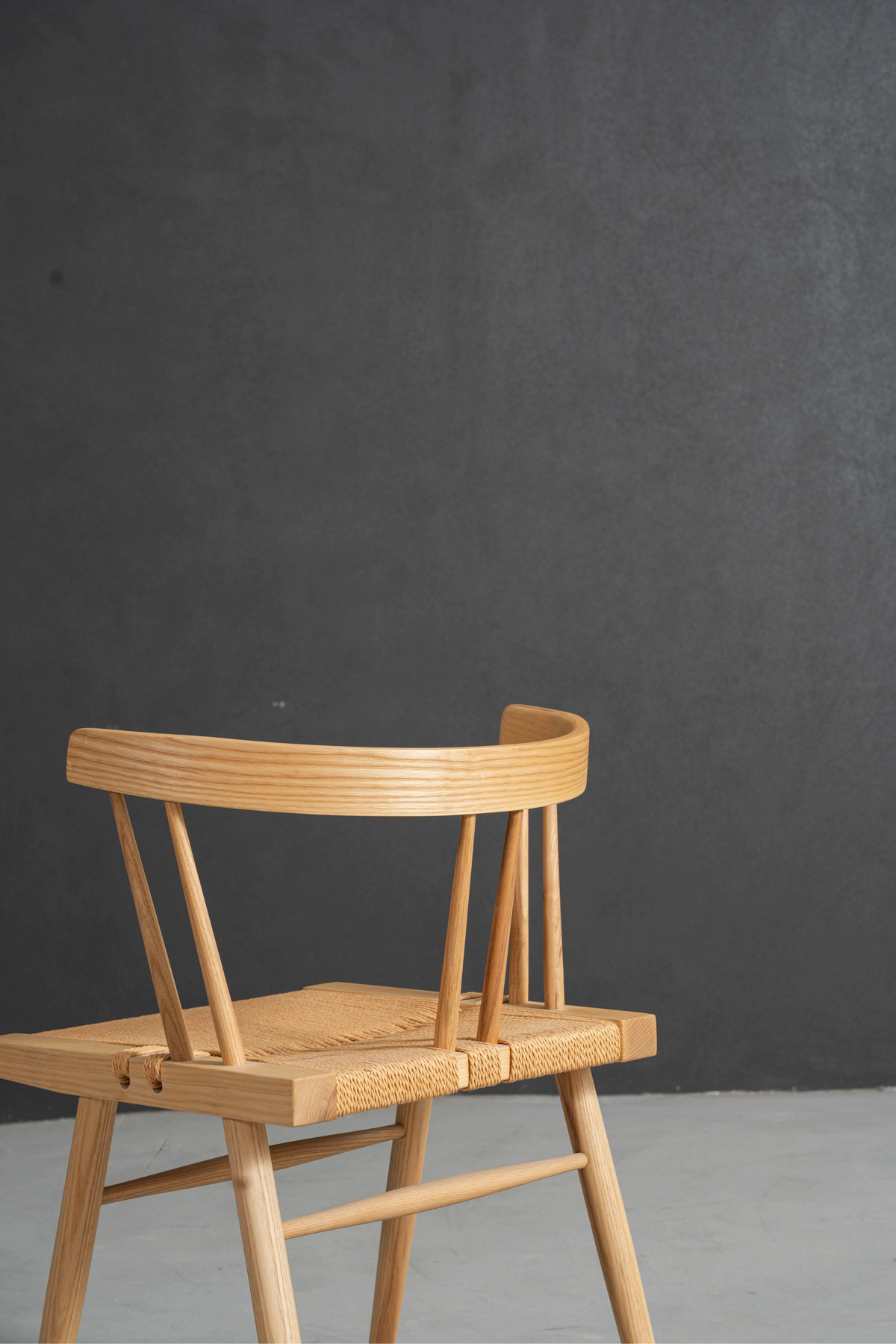 Detailed view of chair's ergonomic back rest curve and seat frame integration.