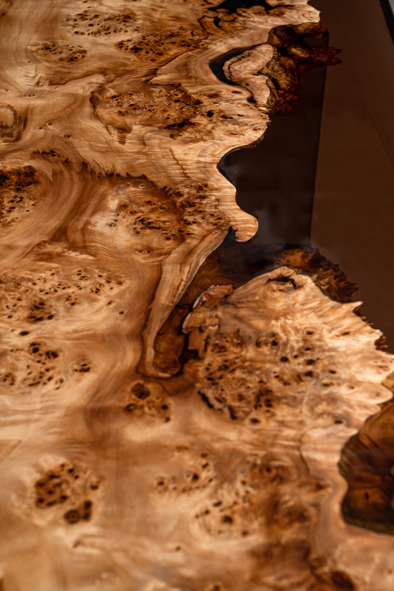Close-up of the Synthesis Table's Mappa Burl grain and epoxy resin features.