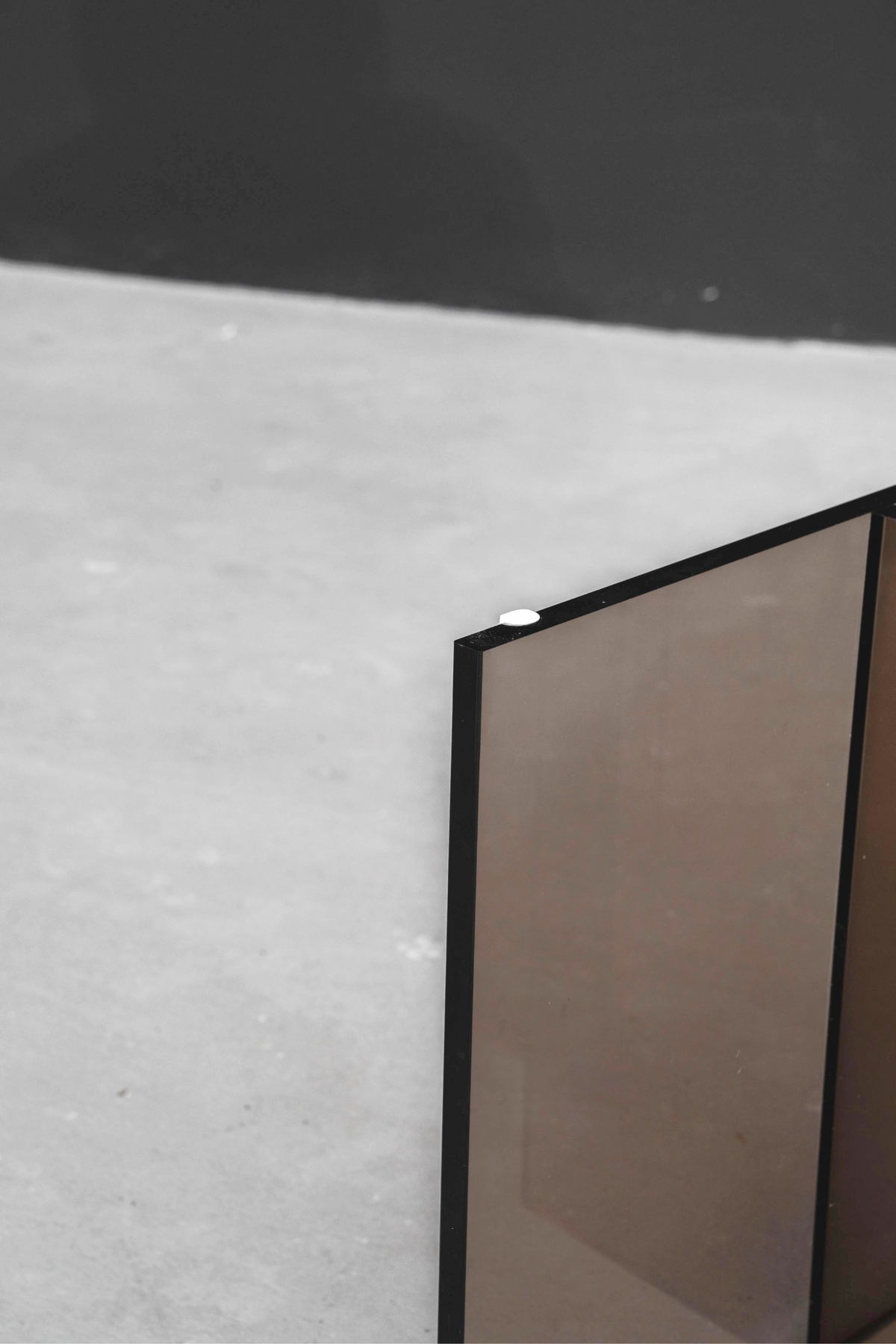 Detailed view of the earth tone acrylic Whispering T base, highlighting its warm, translucent quality and clean lines.