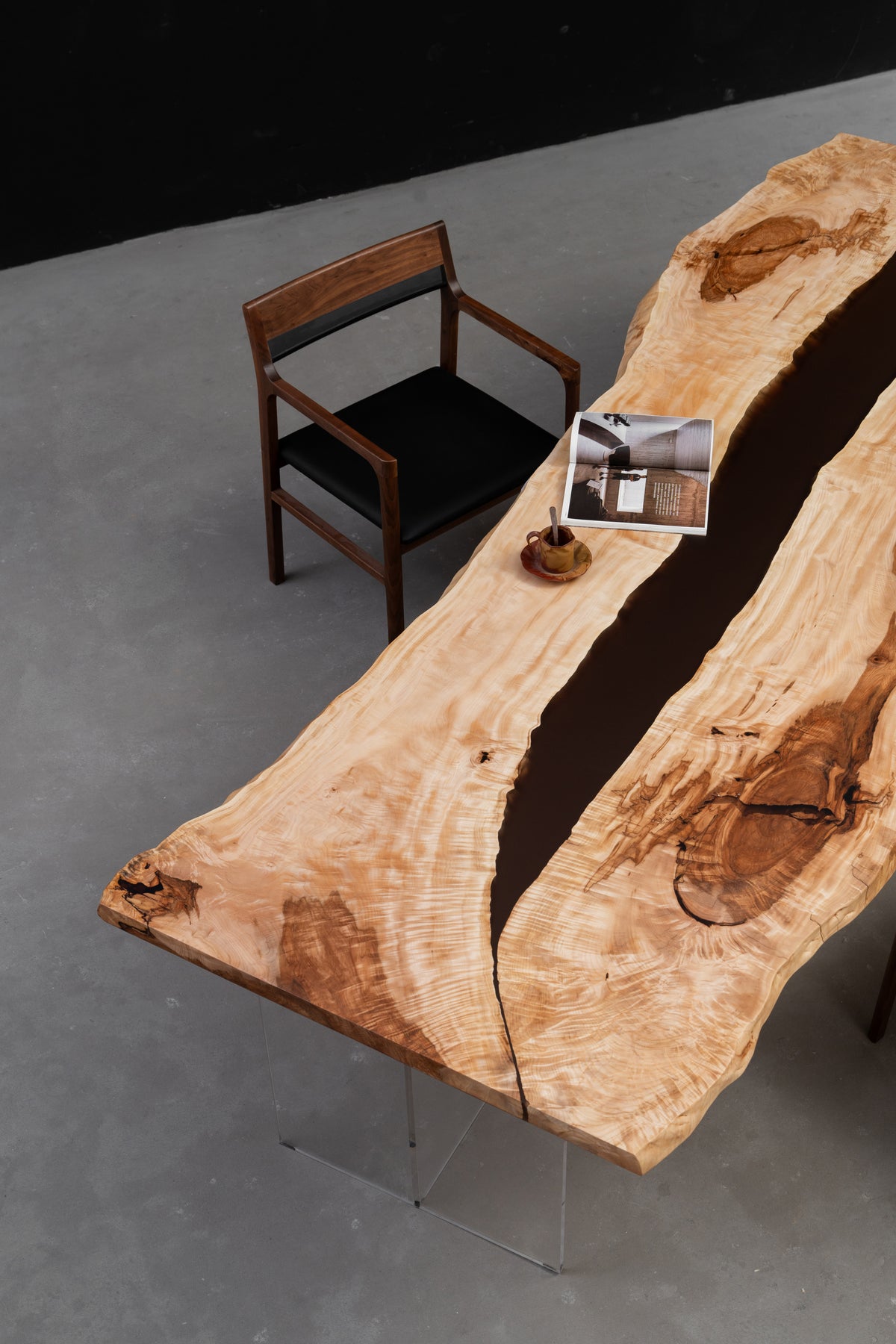 Three-quarter view of the Tochi Horizon  table, showcasing Japanese horse chestnut grain, live-edge contours, and resin river.