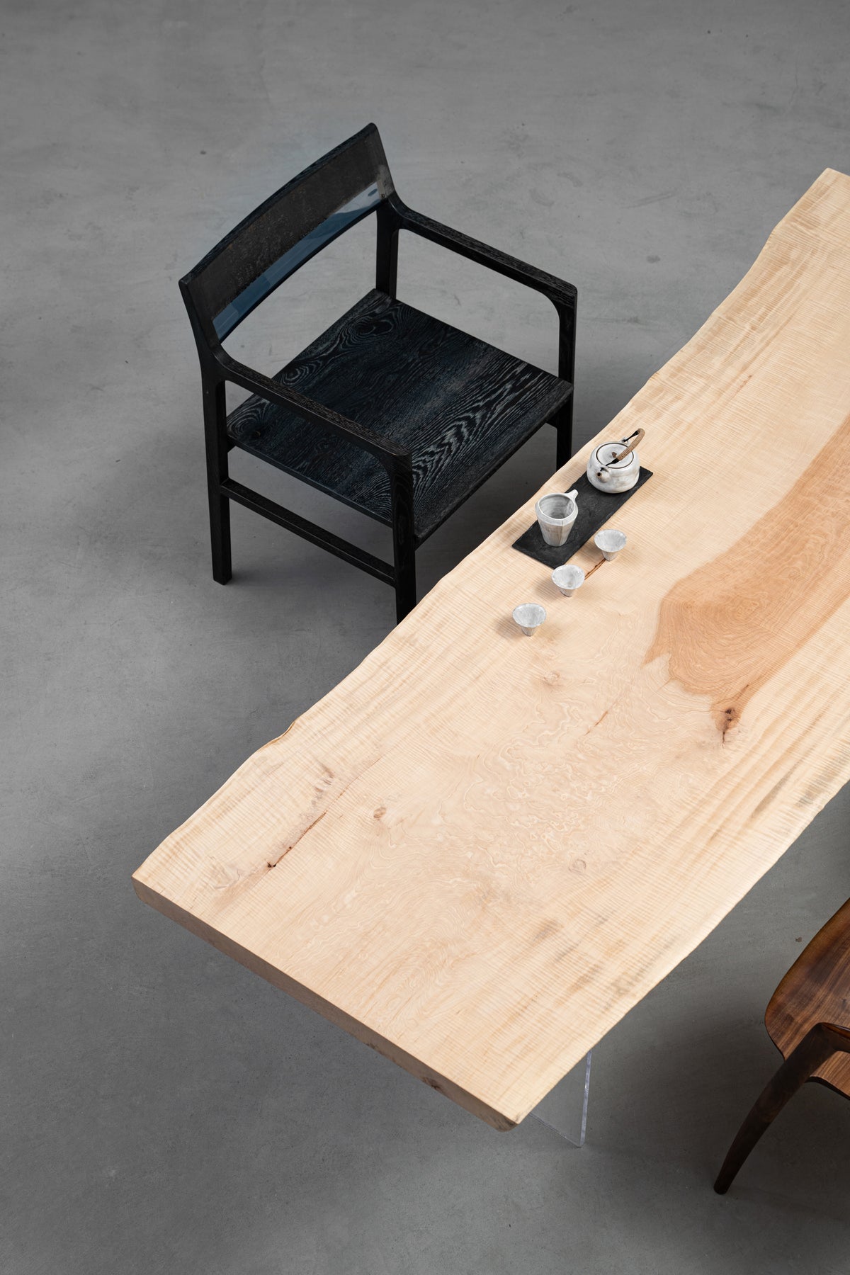 Three quarter view of Tochi Kodama live-edge Japanese Tochi table highlighting luminous pale wood and natural contours.