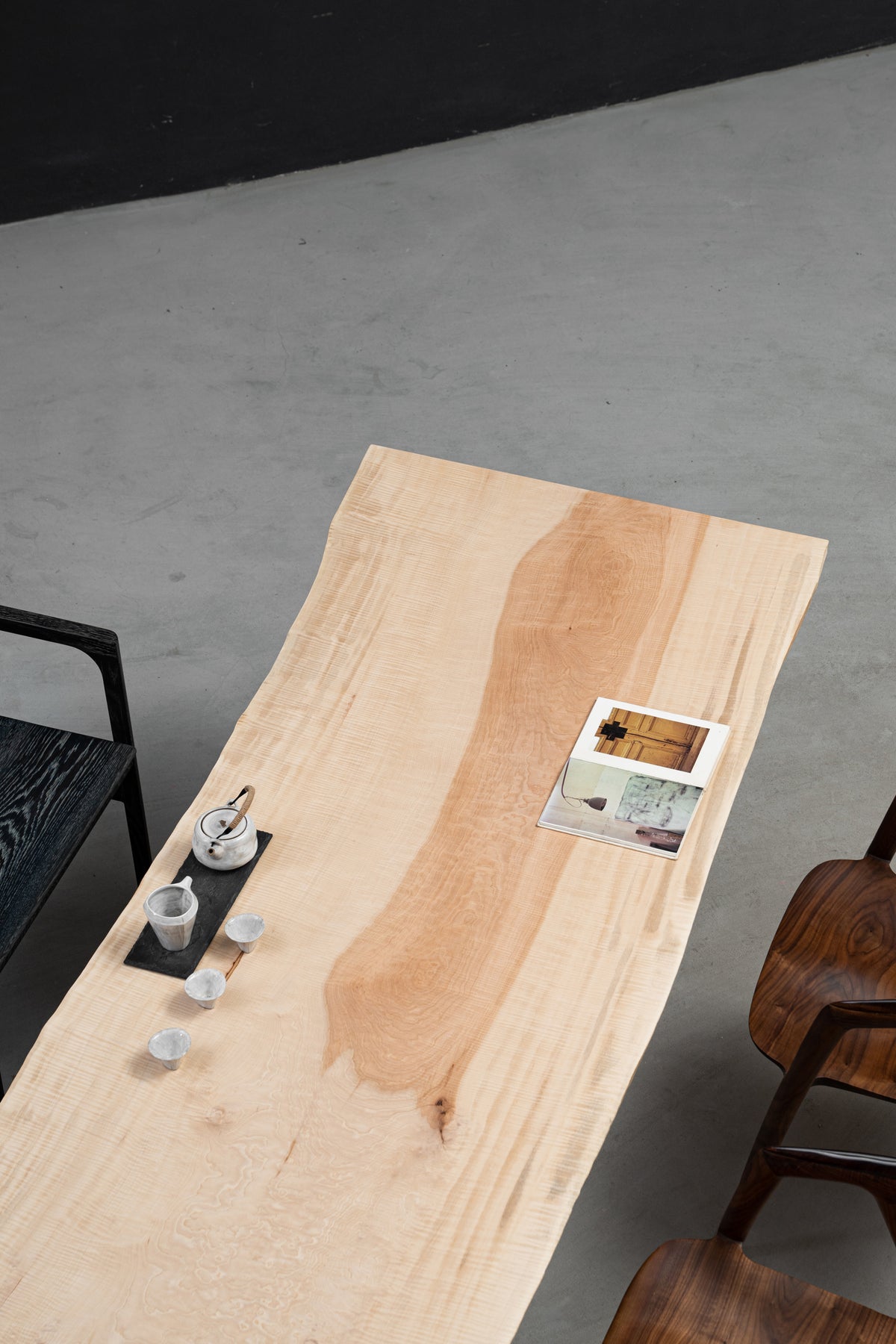 Three-quarter top view of Tochi Kodama live-edge Japanese Tochi table highlighting luminous pale wood and natural contours.