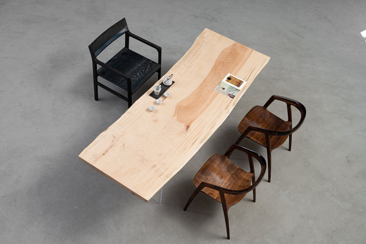 Full view of Tochi Kodama Japanese live-edge dining table highlighting calm grain and sculpted edges