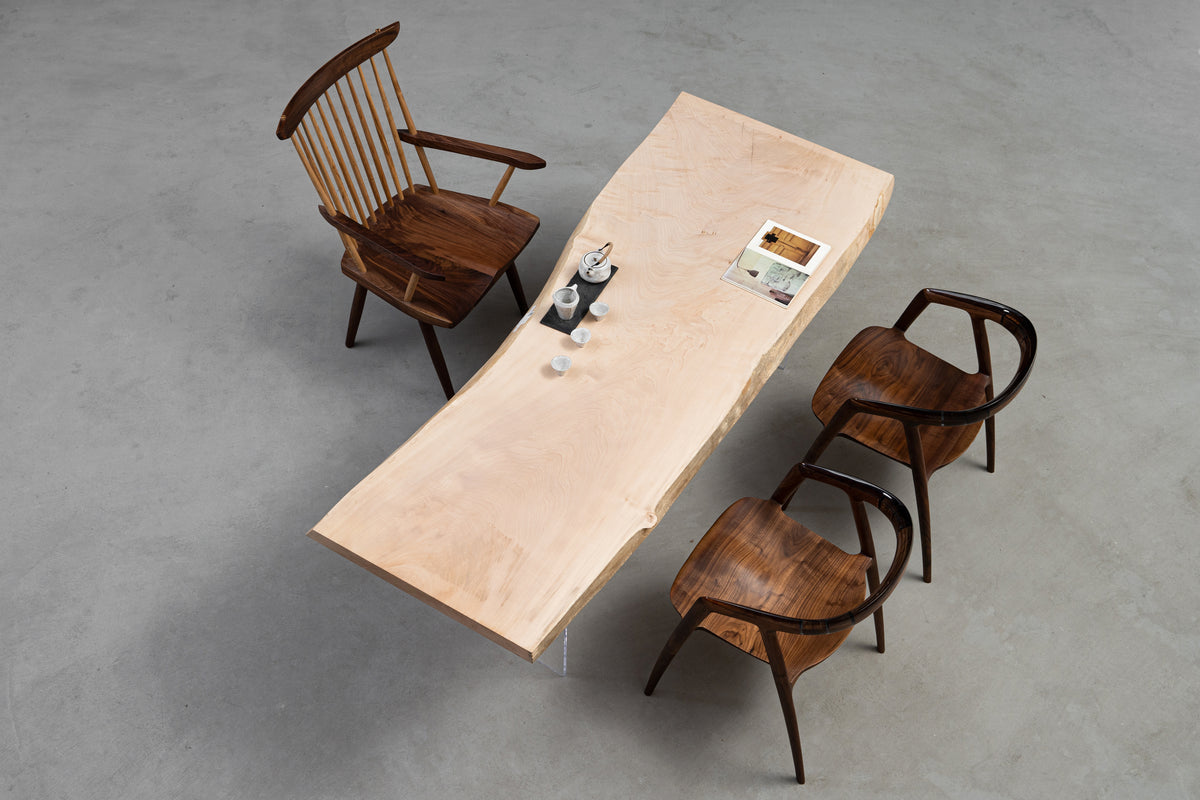 High-angle wide view of the Tochi Veil statement table, capturing the live-edge organic shape and 2-meter span