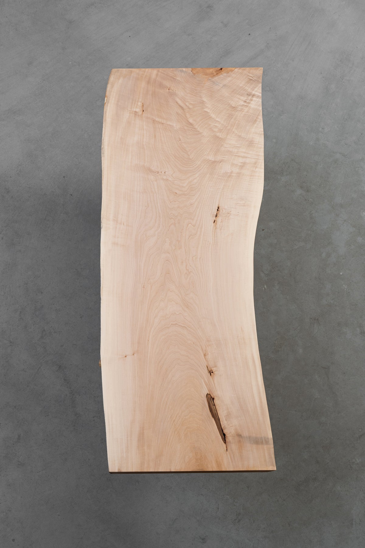 Alternative underside vertical view of the Tochi Veil slab highlighting the unique grain flow and light beige consistency.