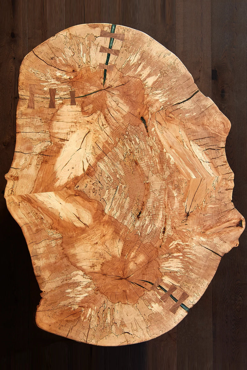 Spalted beech wood coffee table with live edge. Book-matched grain, cylindrical legs. Organic modern design for living rooms. 