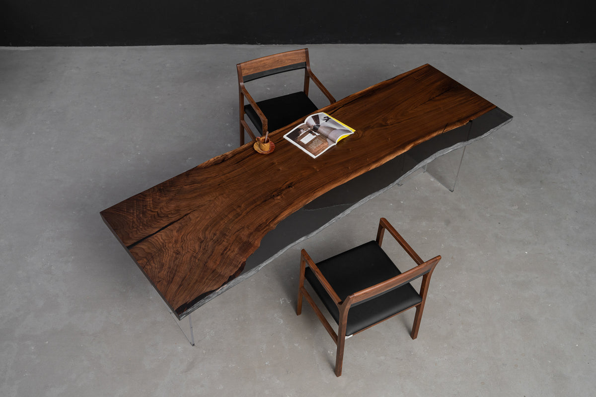 Midnight sculptural wood table placed in a minimalist interior, showing scale, form, and material presence