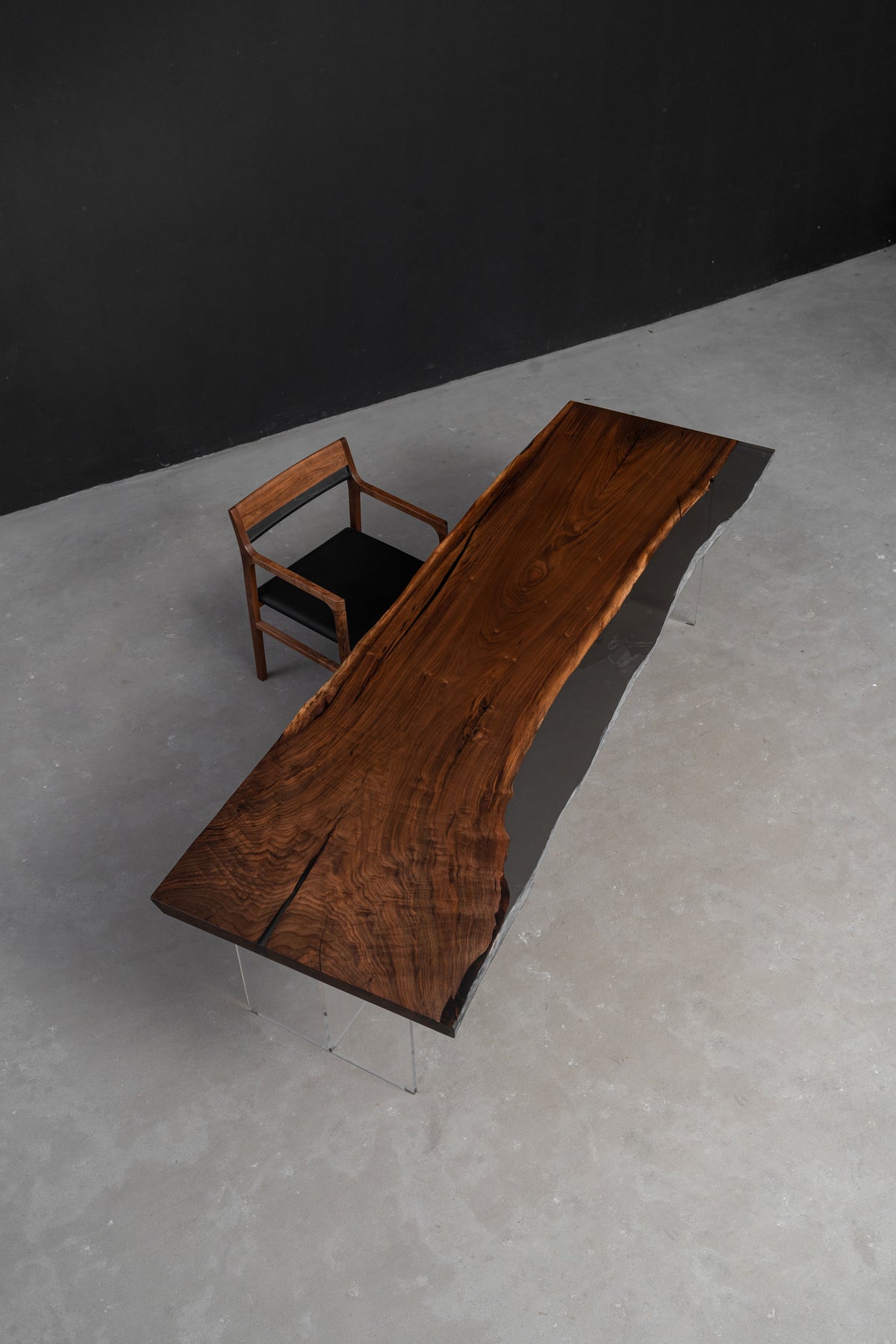 Midnight Duskwood sculptural wood table placed in a studio interior, showing scale, form, and material presence