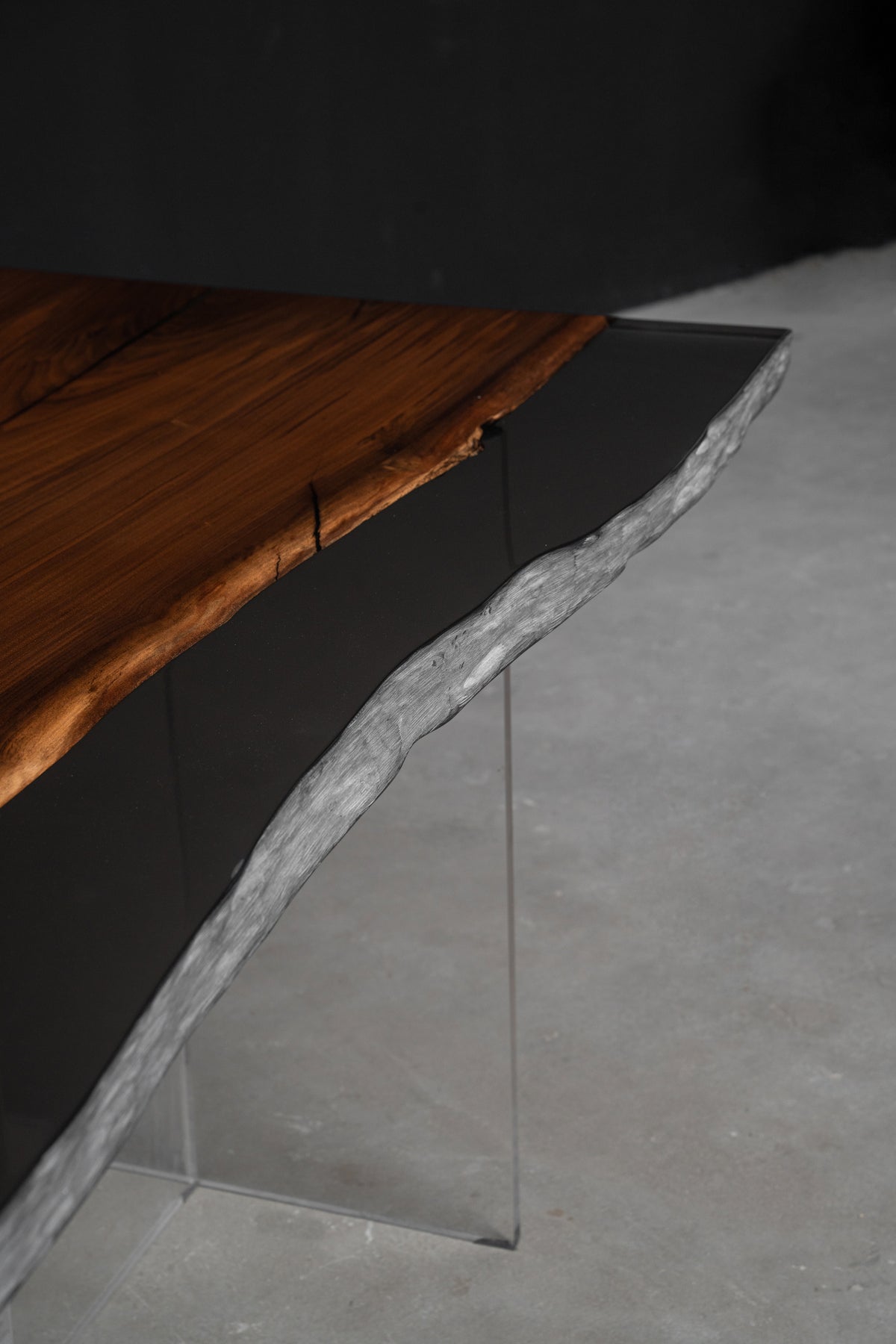 Three-quarter view edge detail of the Midnight Duskwood  table highlighting deep tonal grain, material depth, and balance