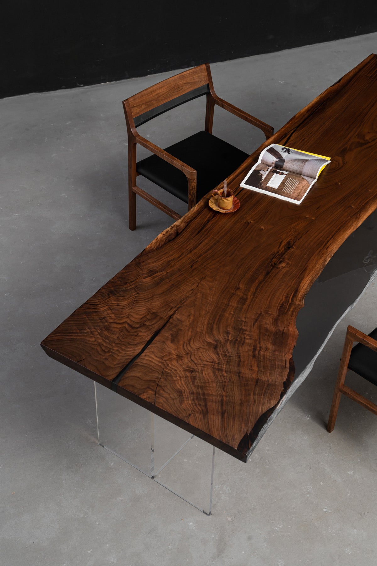 Three-quarter view of the Midnight table highlighting deep tonal grain, material depth, and balanced proportions