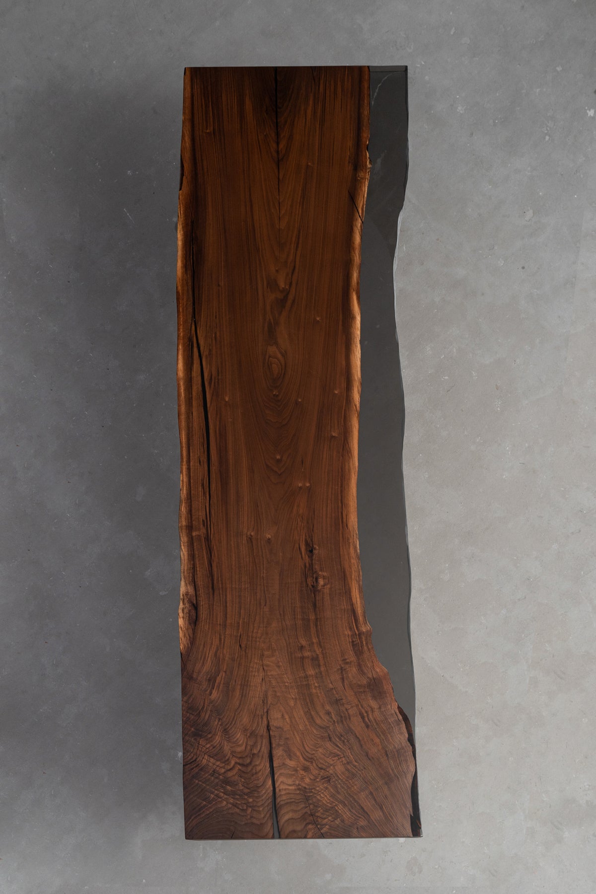 Duskwood Midnight sculptural wood table placed on minimal background, showing scale, form, and material presence