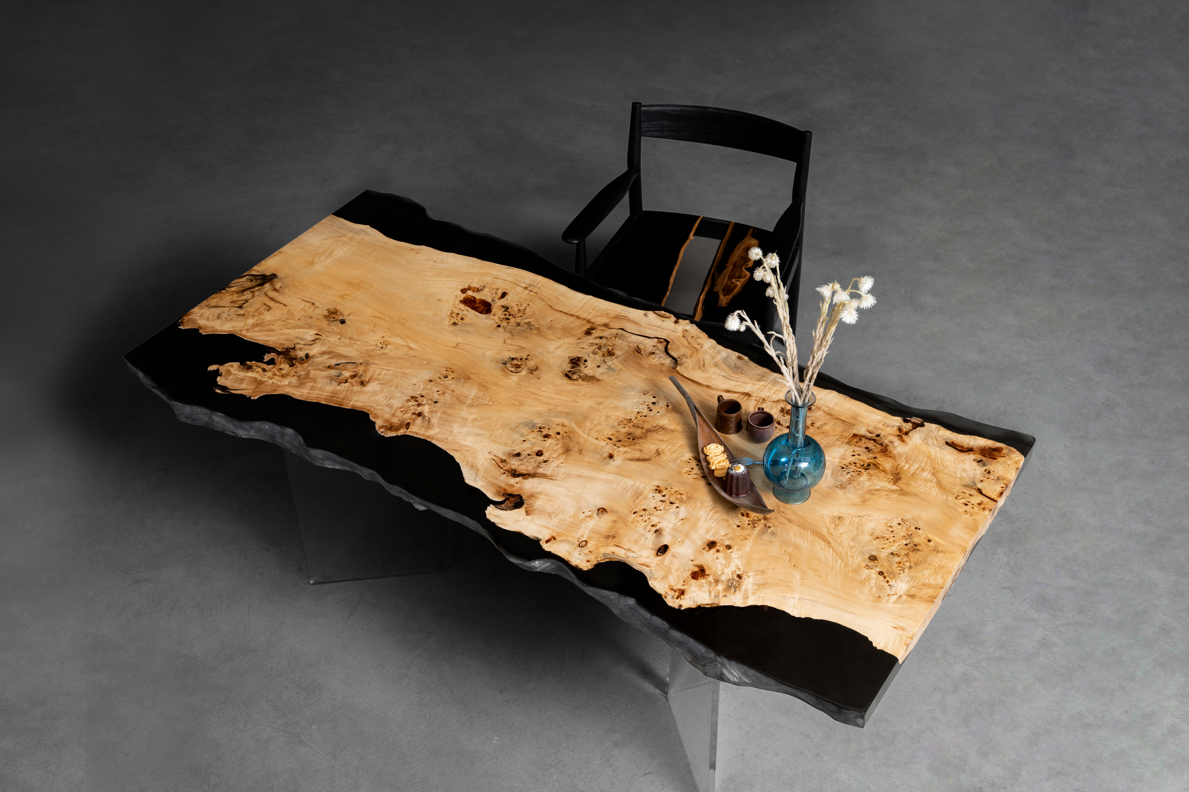 Aerial view of a Mappa Burl slab with deep-pour epoxy river edges, highlighting organic patterns for a luxury live-edge table