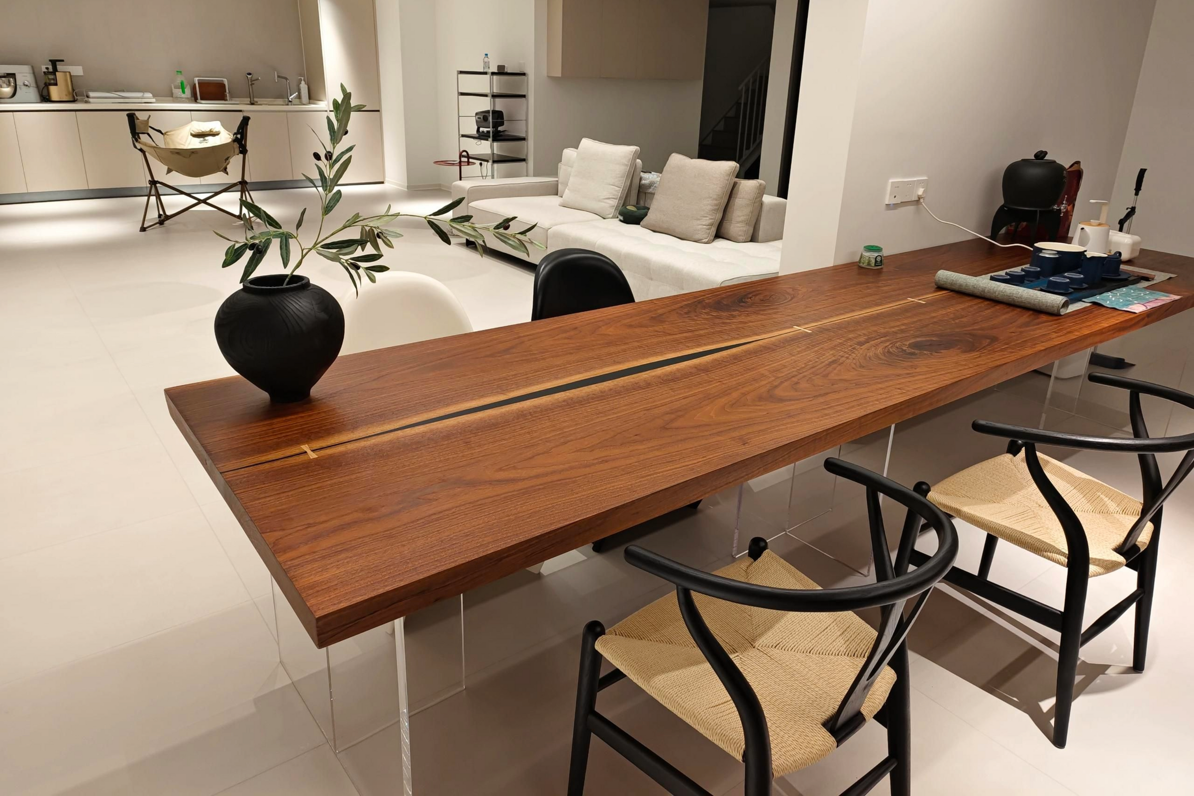 Book-matched live-edge slabs with a glowing epoxy streak in a luxury minimalist interior, showcasing symmetrical wood grain. 