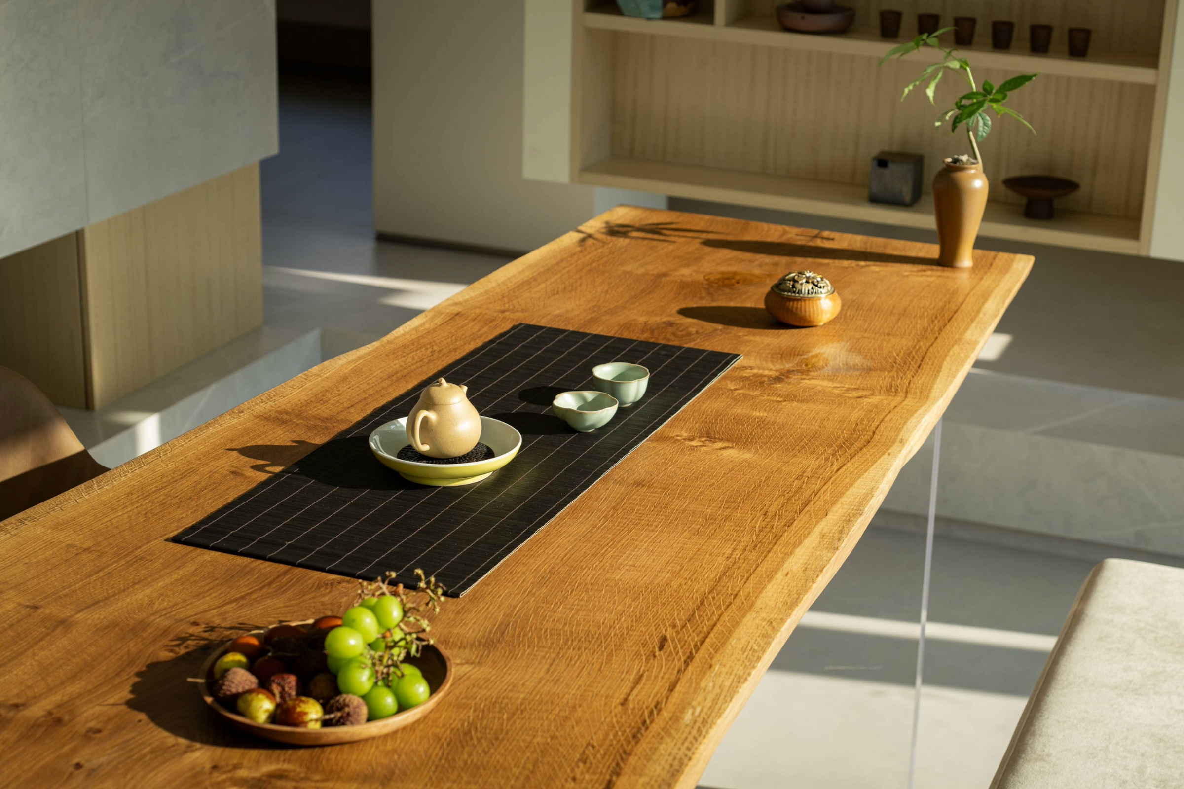 Modern dining room with a live-edge wood slab table, highlighting the natural grain and organic shape of the design.