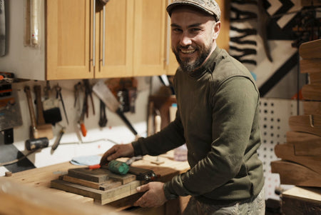 Egor Ivoilov in the workshop standing beside a workbench during furniture making.